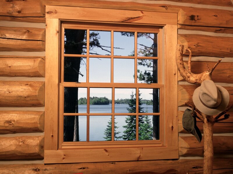 Log cabin window with lake view