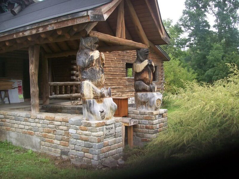 Log cabin with bear sculptures