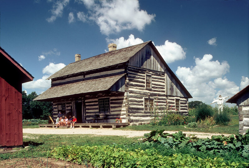 Log cabin with family on porch