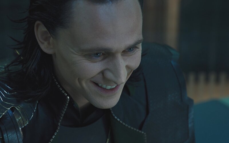 Loki smiling in dark setting