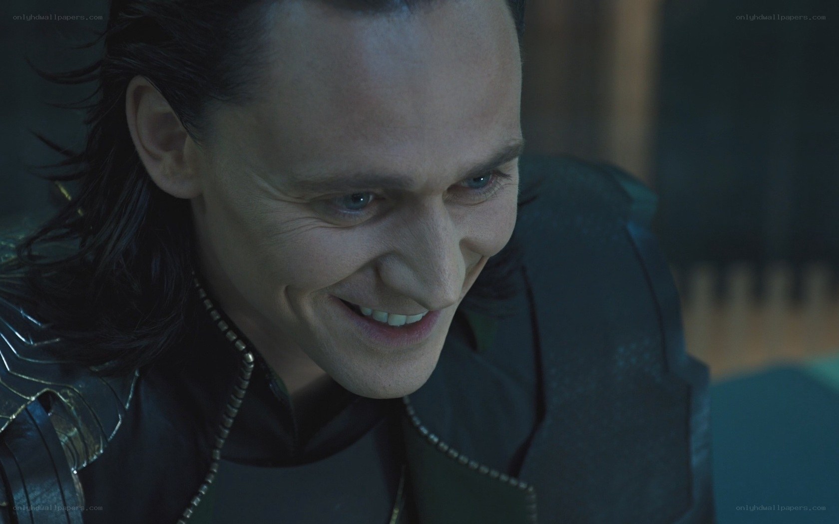 Loki smiling in dark setting