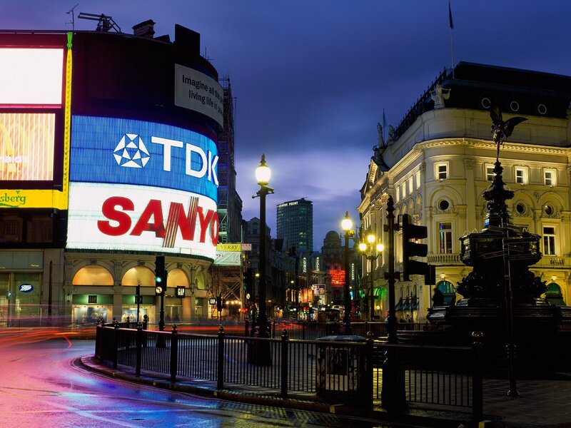London at dusk with bright billboards