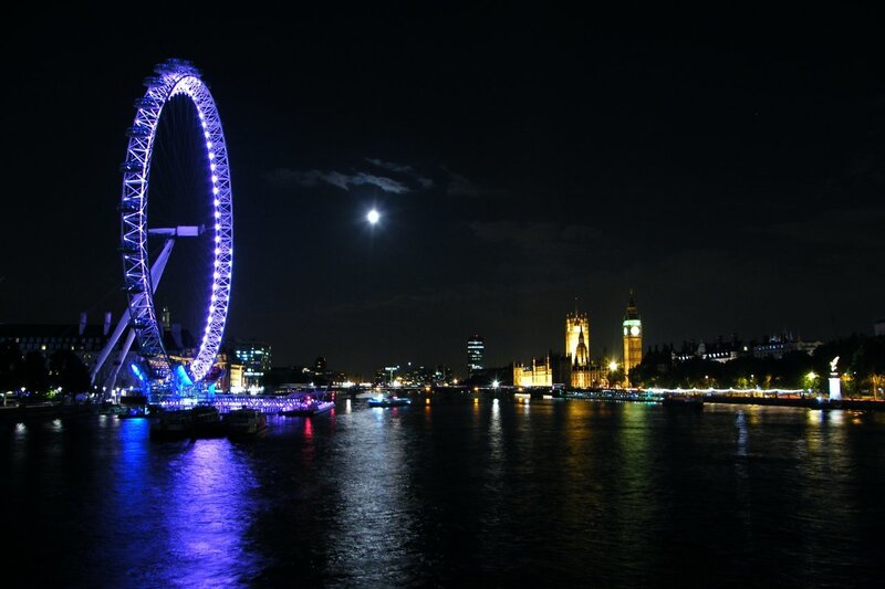 London Eye at night with moon