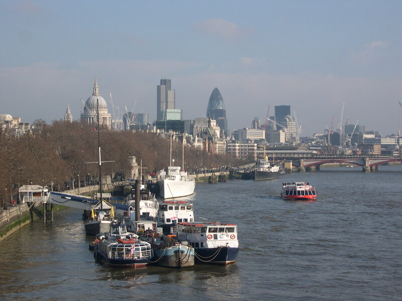 London skyline with boats on the Thames