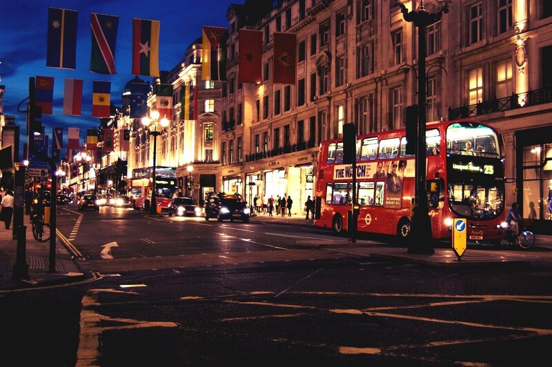 London street at night with double-decker bus