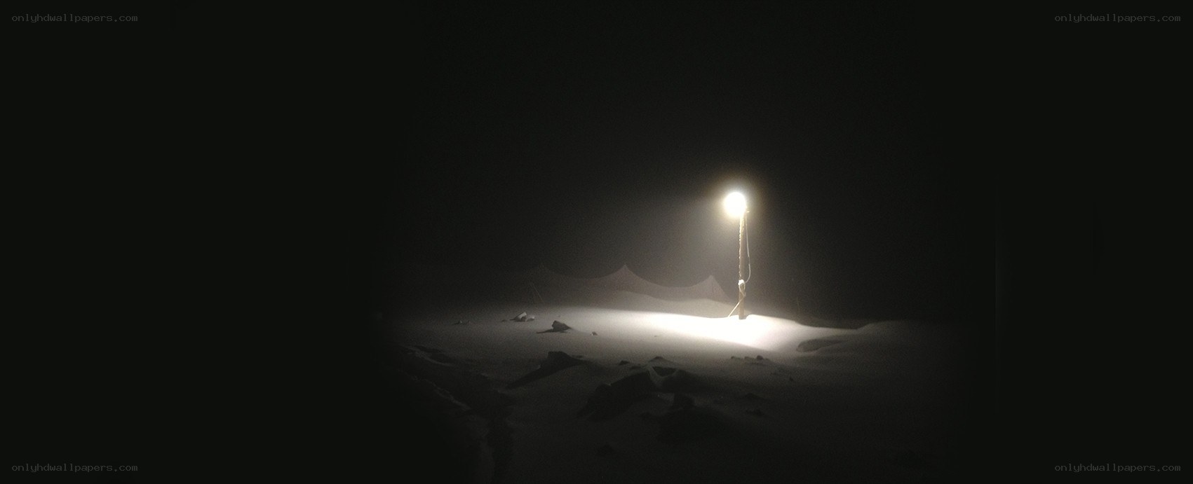 Lone lamp in a dark desert