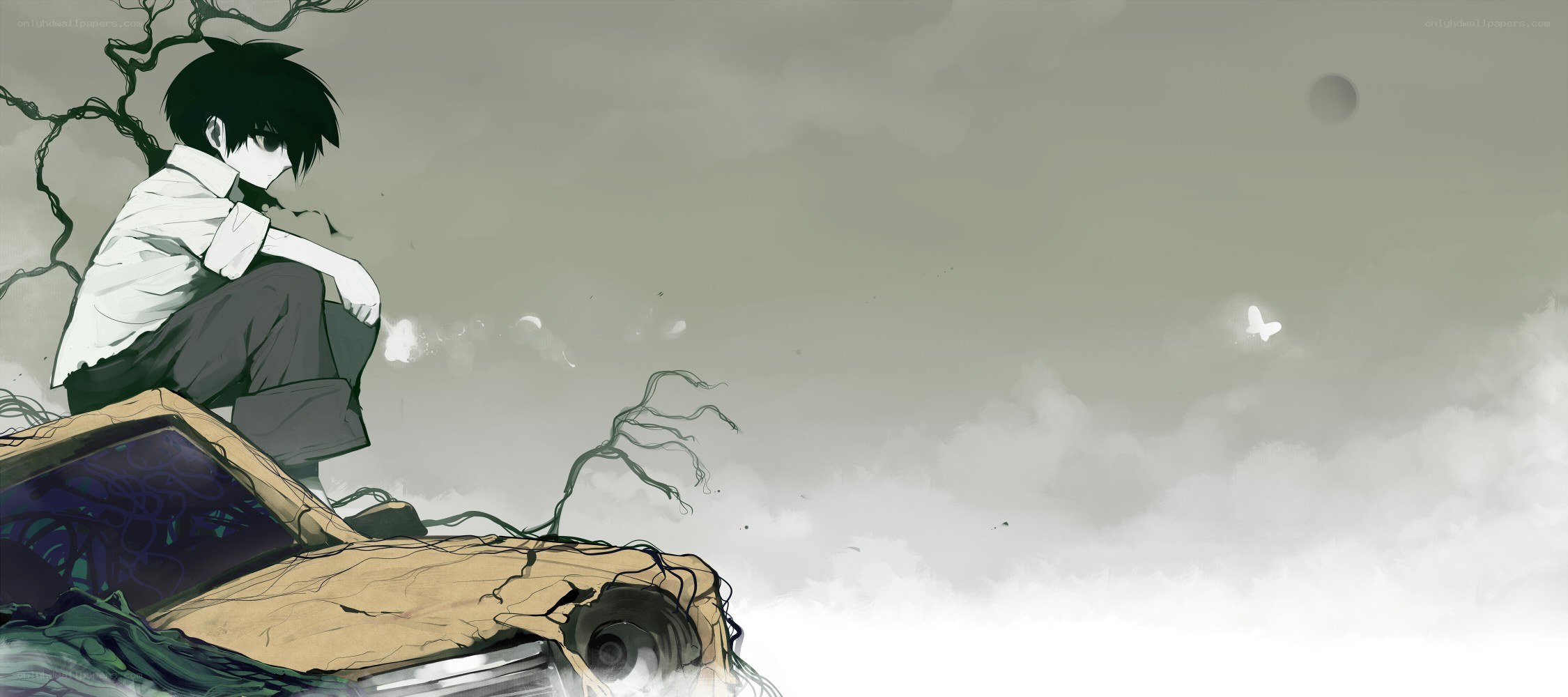 lonely boy on a ruined car