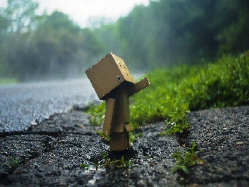 lonely cardboard figure in rain