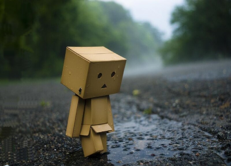 lonely cardboard figure in rain