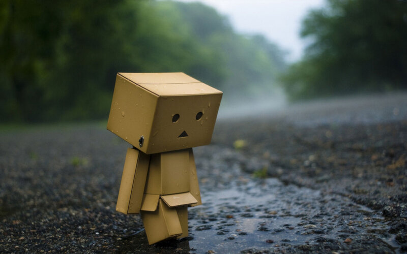 lonely cardboard figure in rain