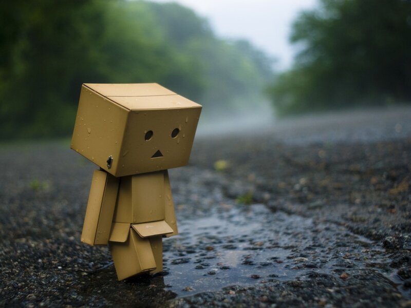 lonely cardboard figure in rain