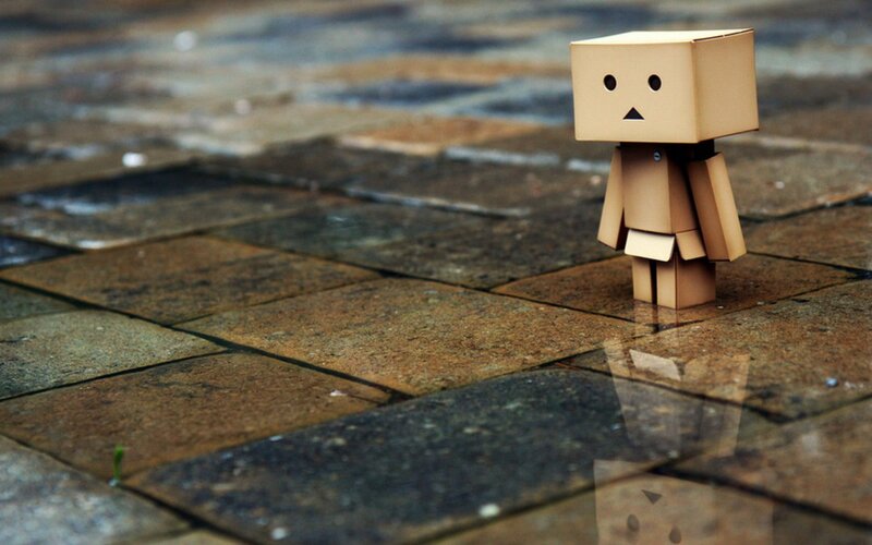 lonely cardboard figure on pavement