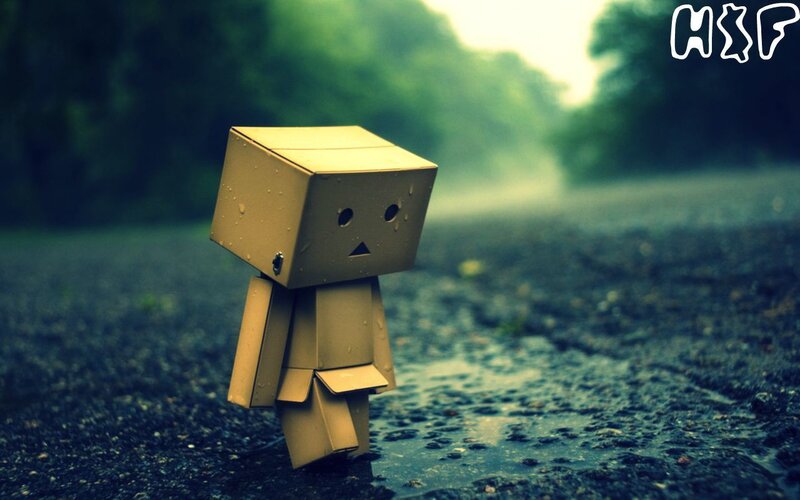 lonely cardboard robot in rain