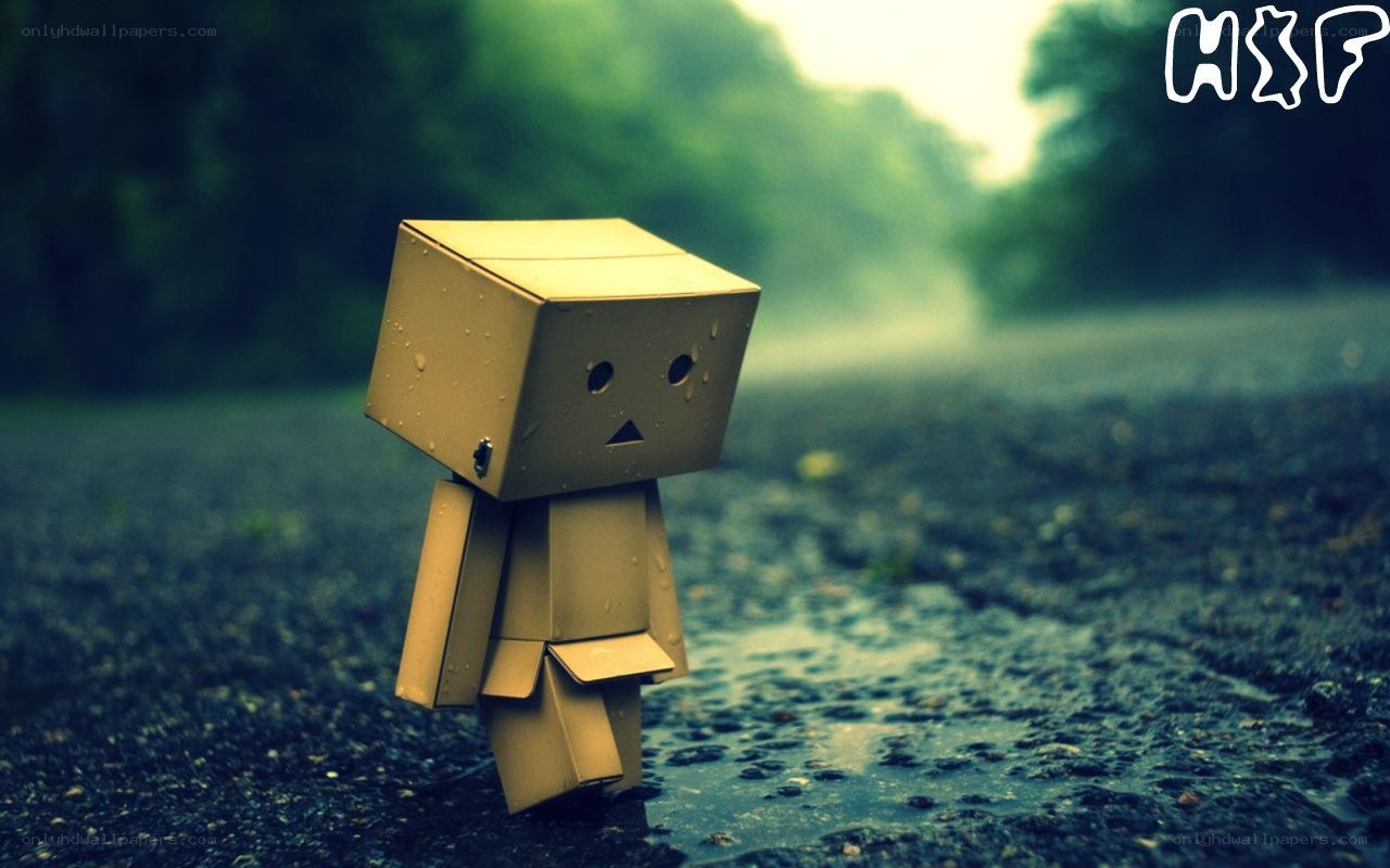 lonely cardboard robot in rain