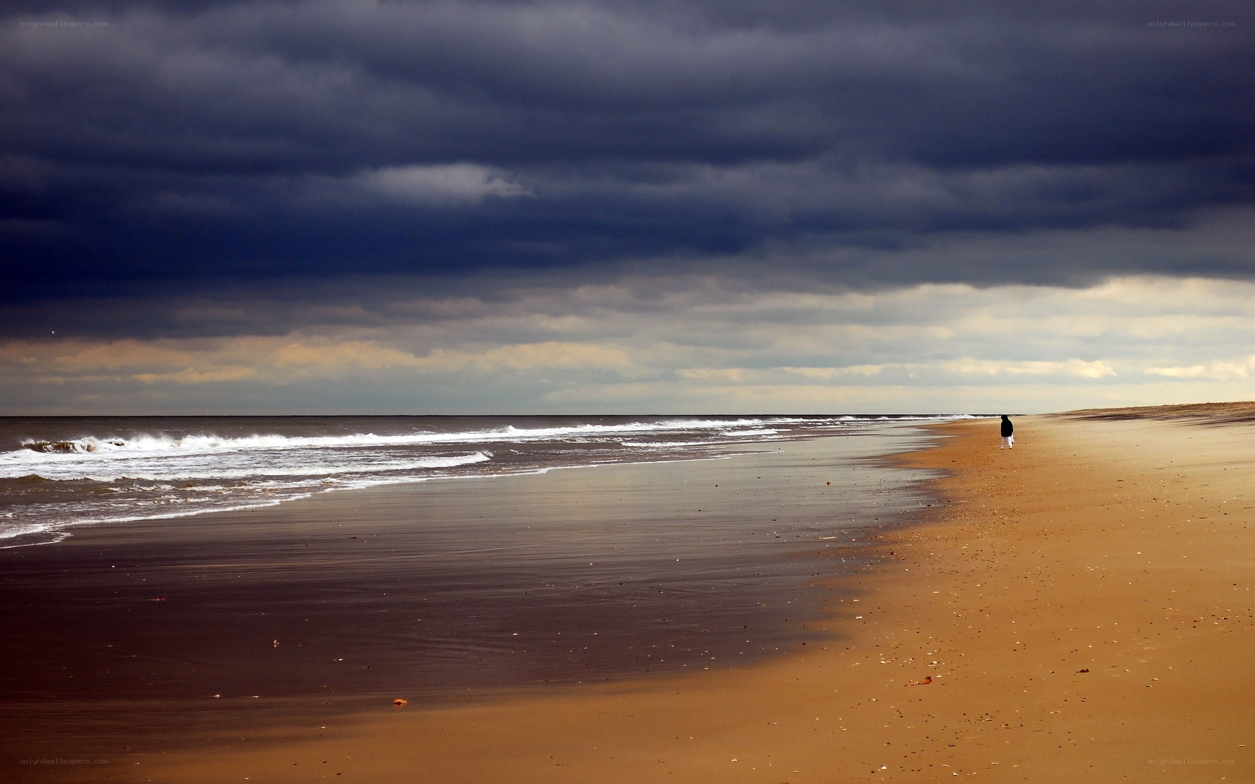 lonely figure on stormy beach