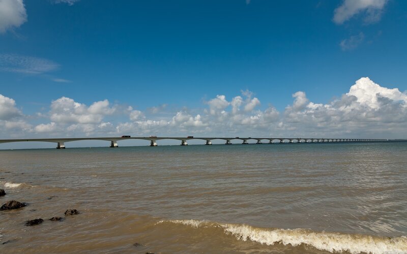 Long Bridge over Water — Blue, Serene, Afternoon, Photograph, Sea