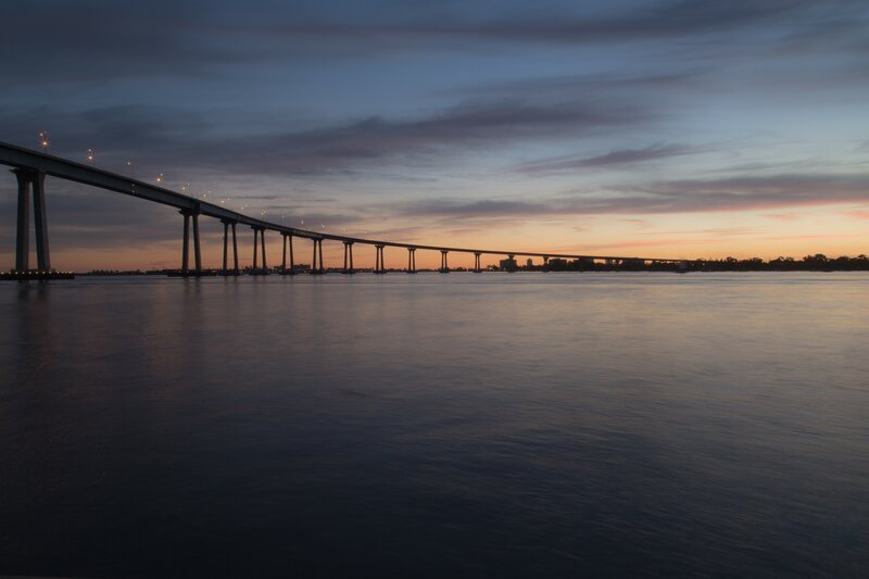 Long Bridge over Water — Blue, Serene, Sunset, Photograph, Sky