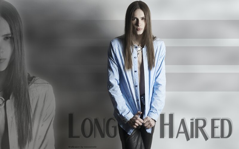 long-haired person in blue shirt