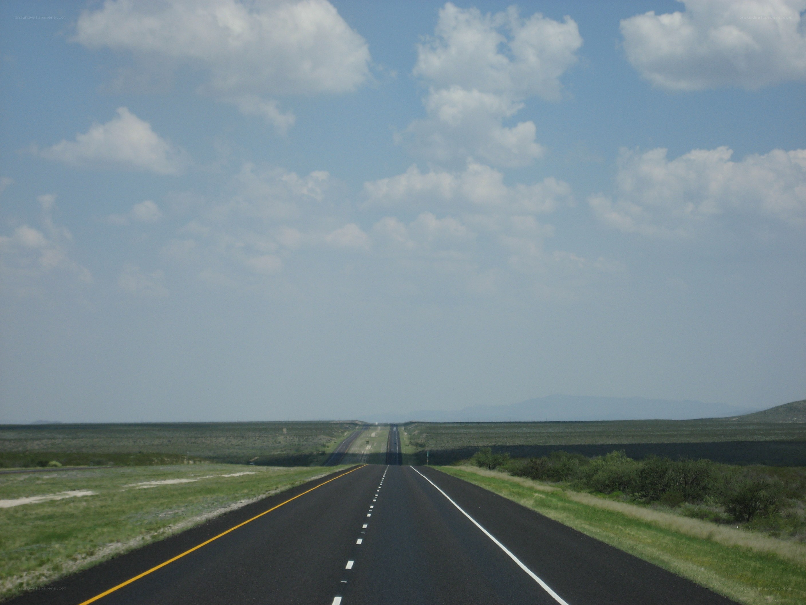 long highway in desert landscape