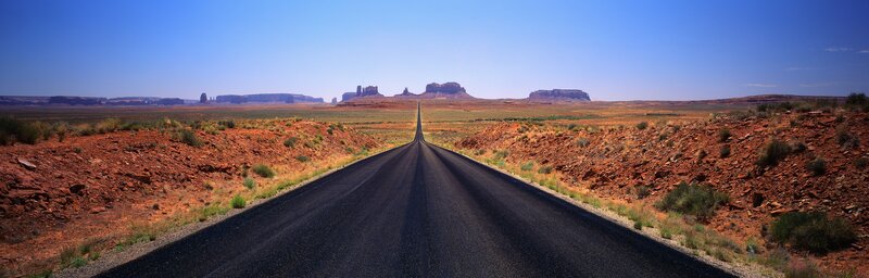 Long Road in Desert — Blue, Serene, Afternoon, Photograph, Rock Formations