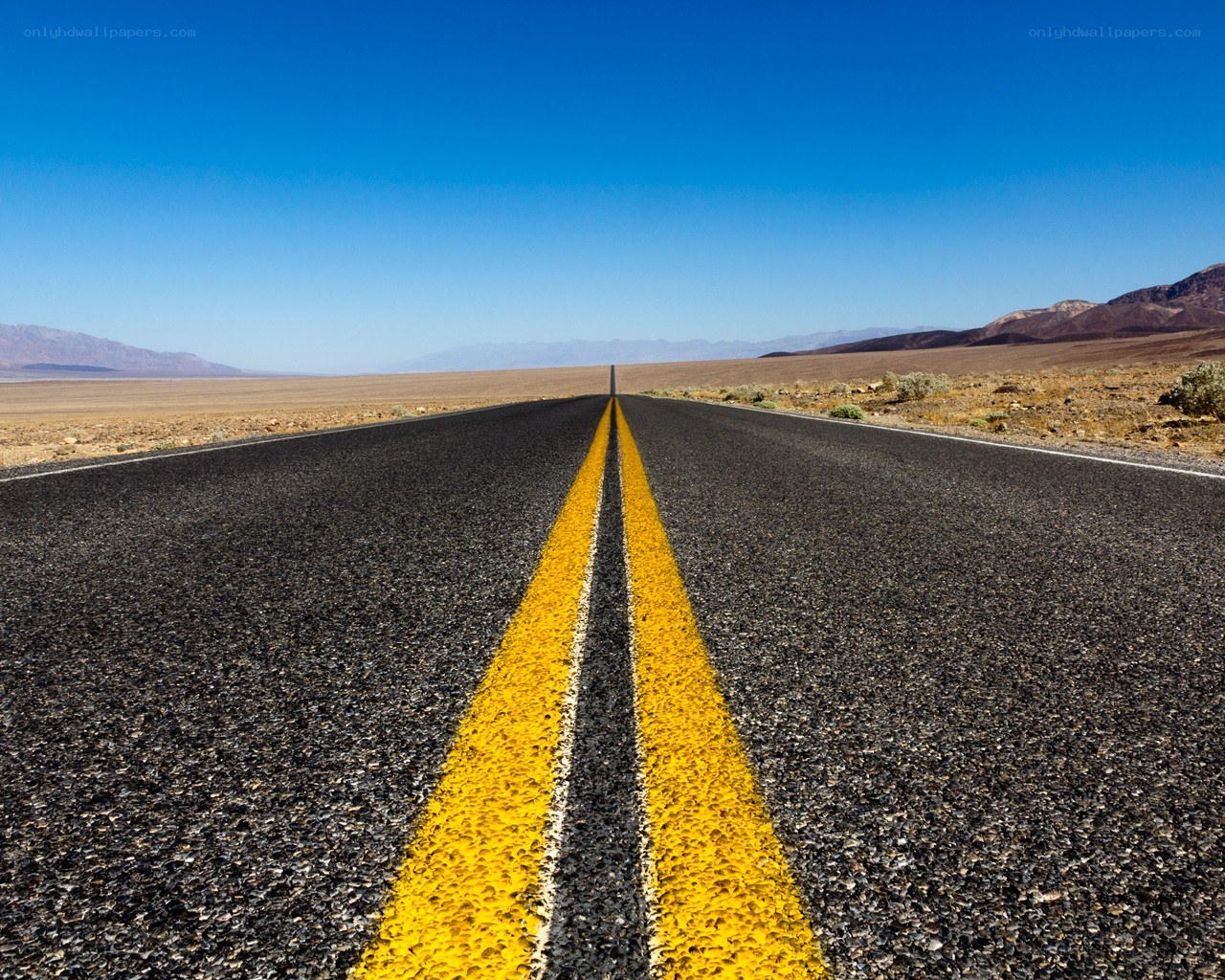 Long road in desert landscape