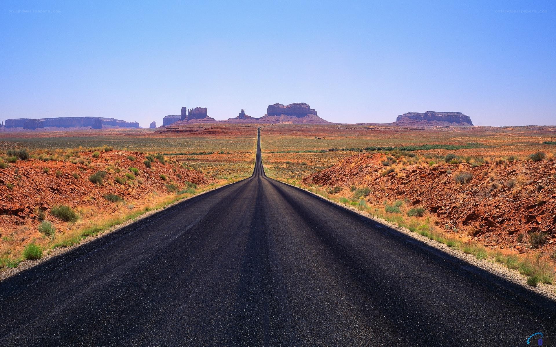 Long road in desert landscape