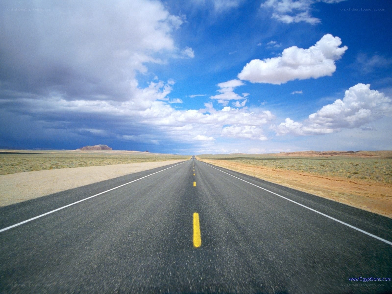 Long road in desert landscape