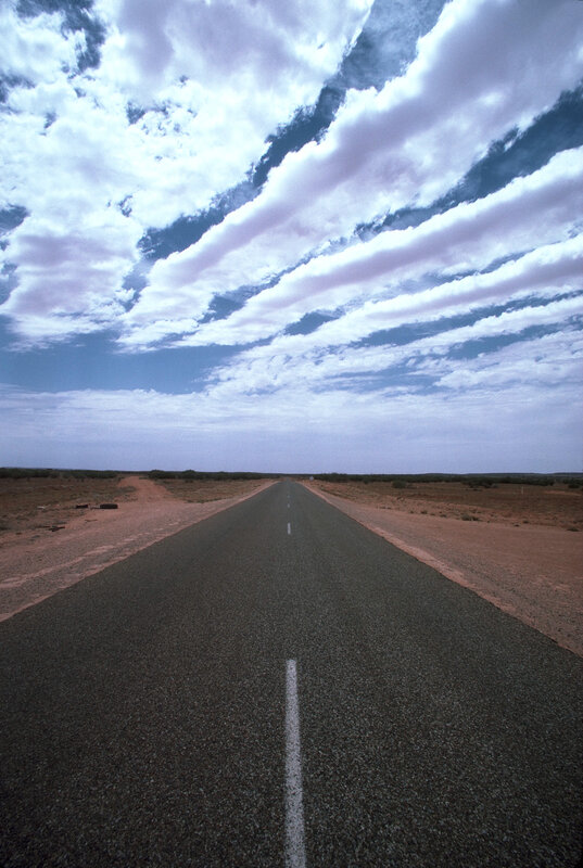 Long road in desert landscape