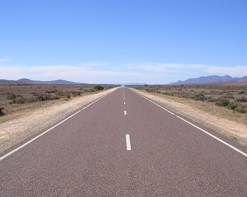 Long road in desert landscape