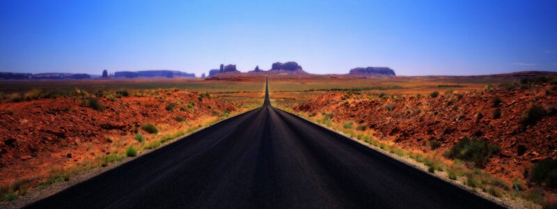 Long road in desert landscape