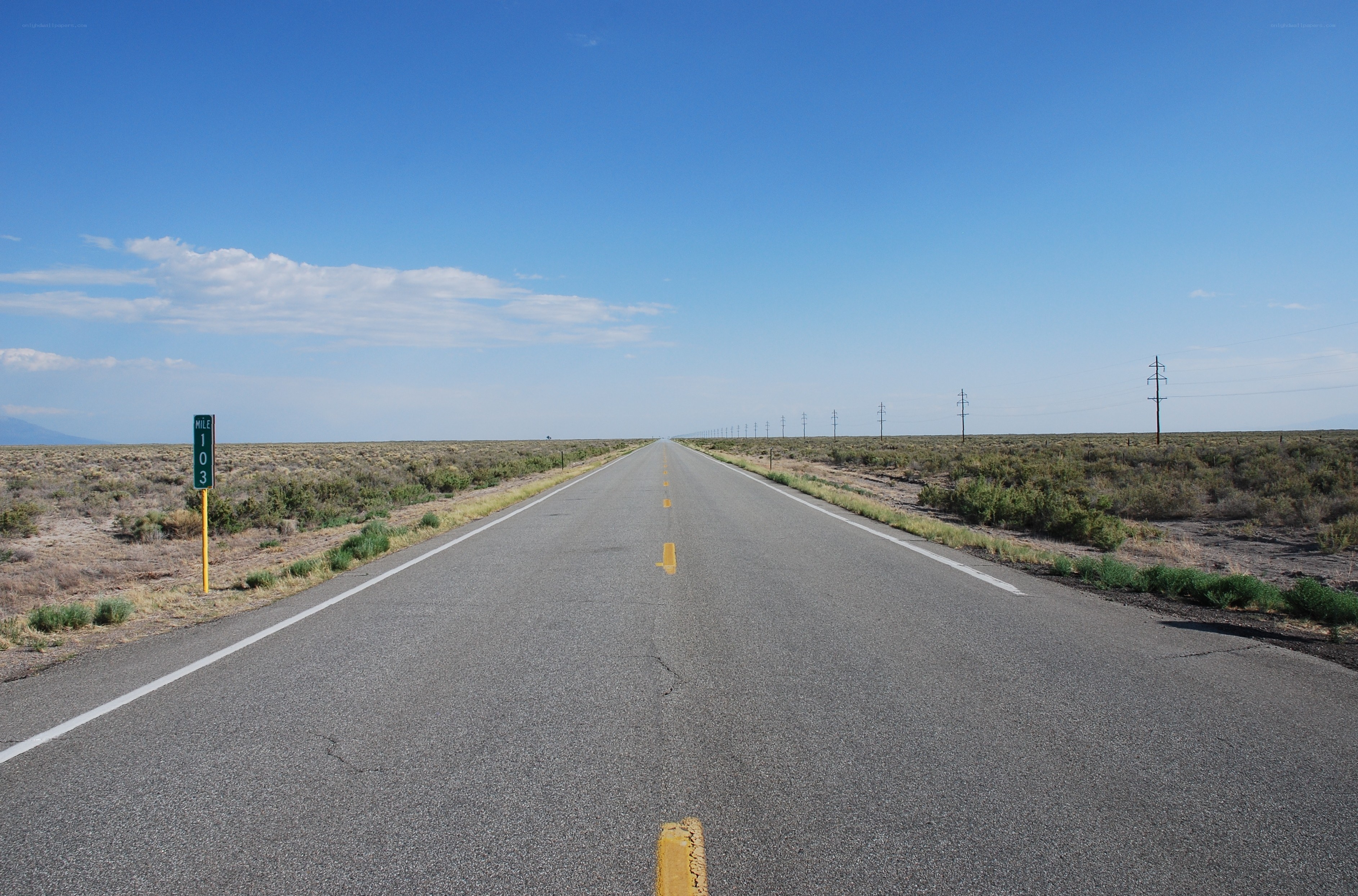 Long road in desert landscape