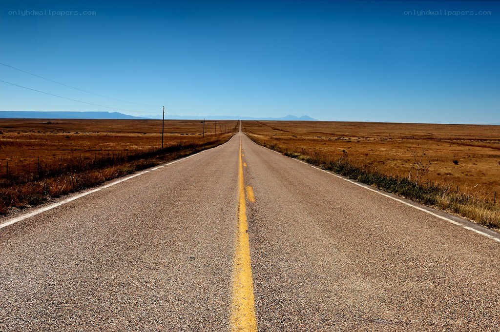 Long road through a desert landscape