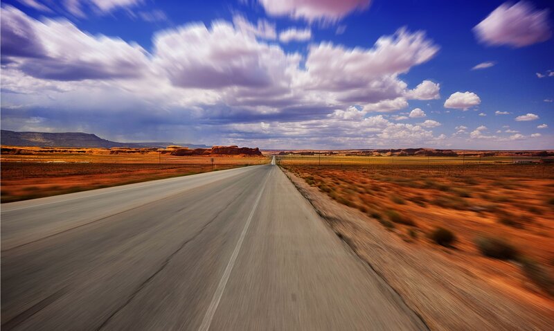 Long road through desert landscape