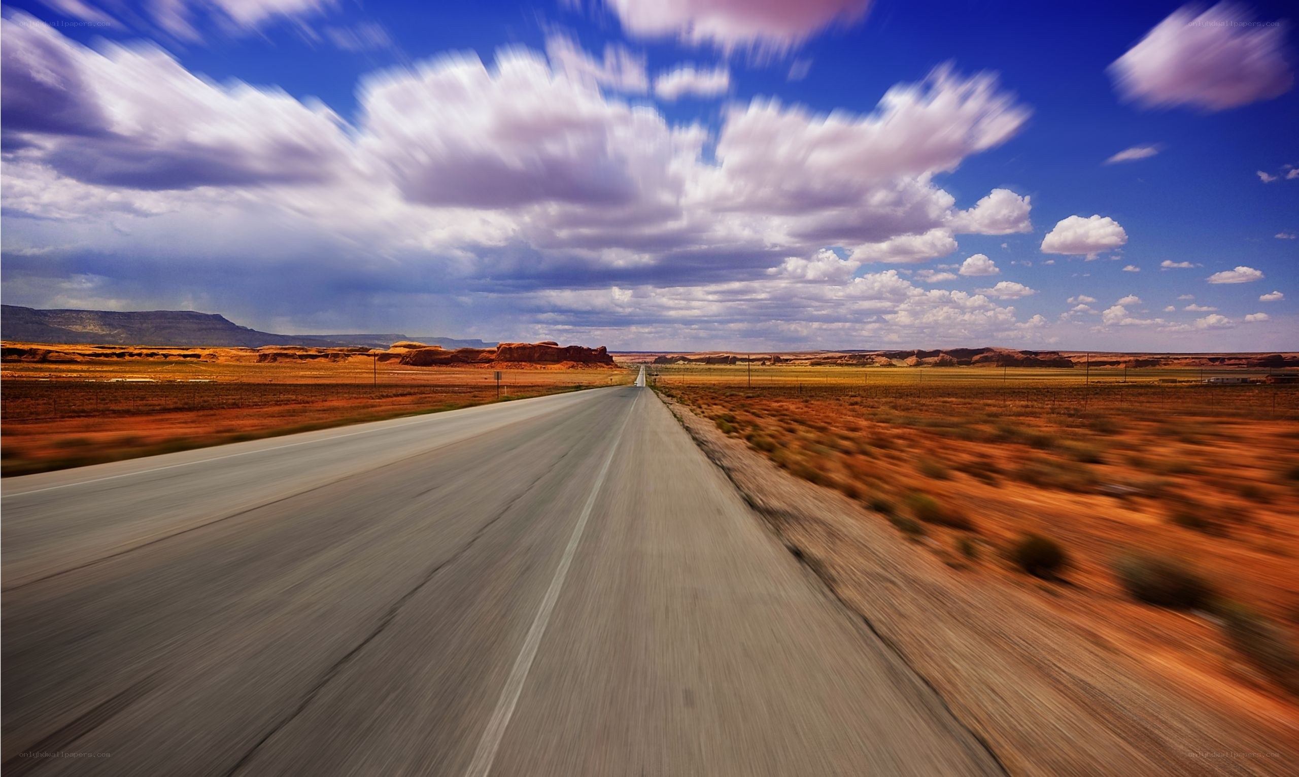 Long road through desert landscape