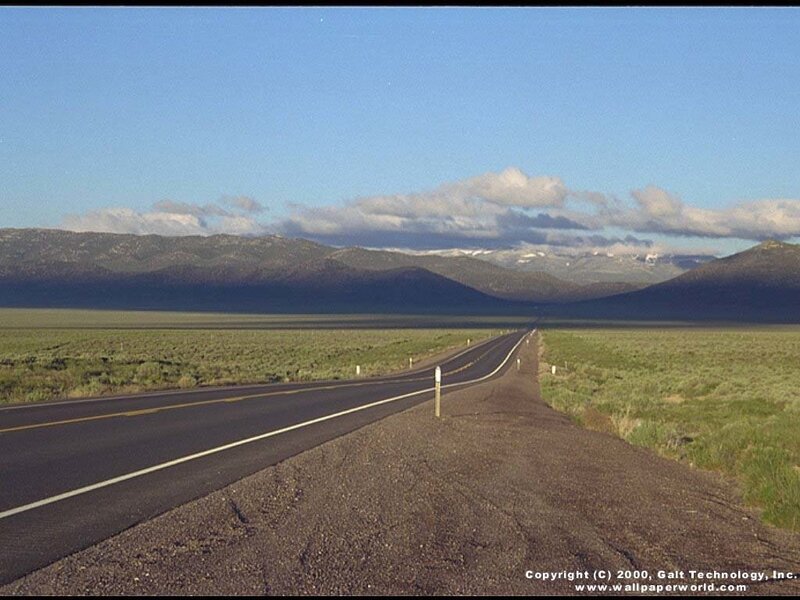 Long road through desert valley