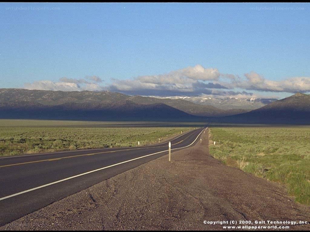 Long road through desert valley
