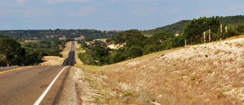 Long road through hilly landscape