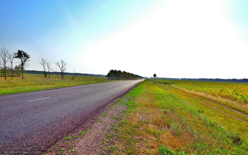 Long road through rural fields