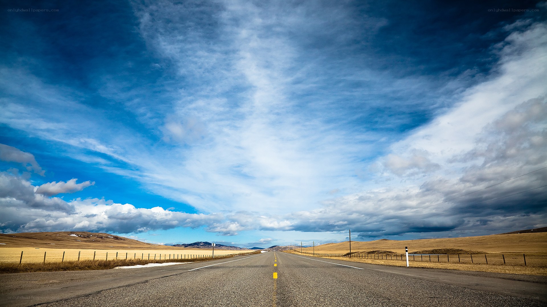 Long road under blue sky