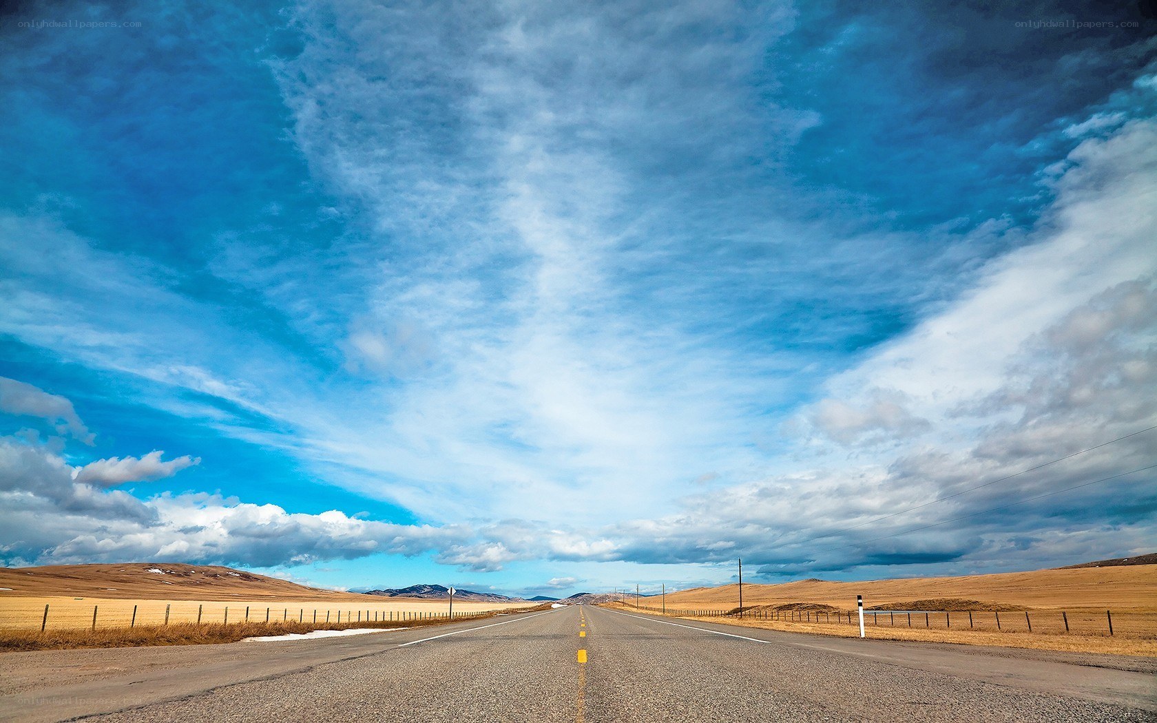Long road under blue sky