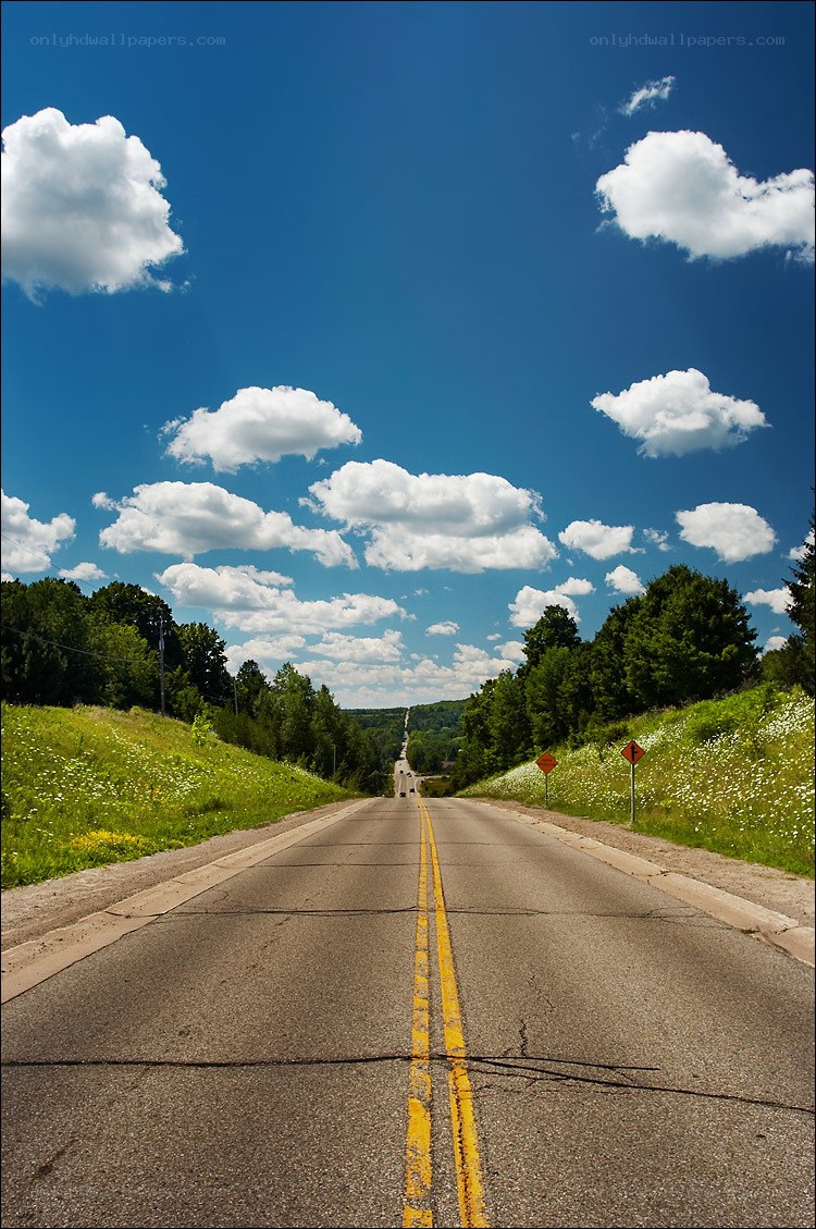 Long road under blue sky