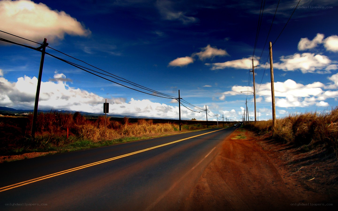 Long road under blue sky