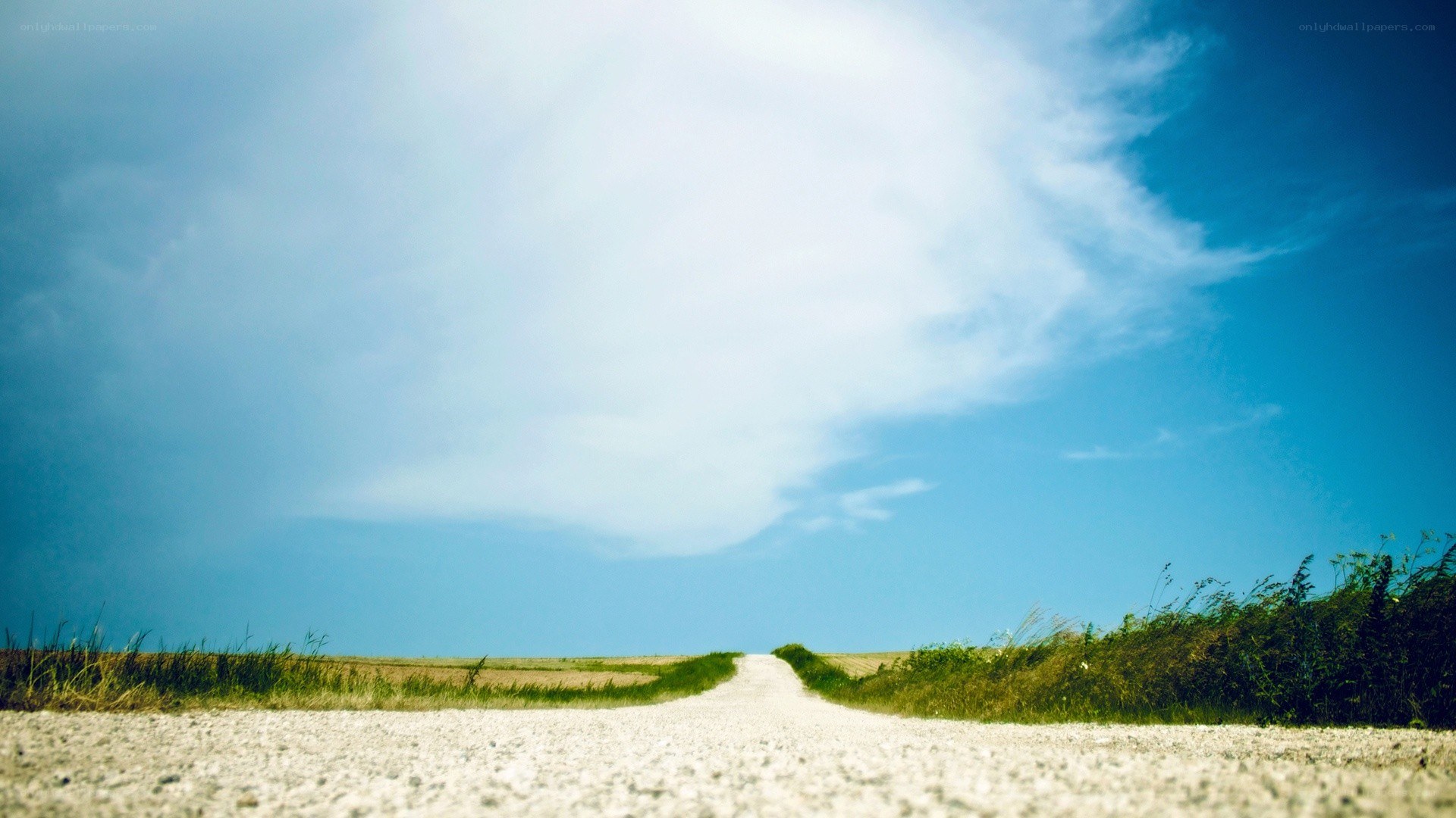 Long road under blue sky