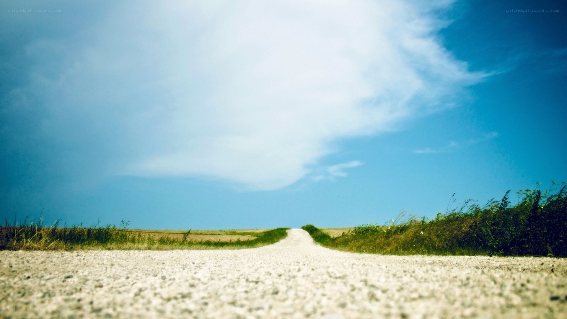Long road under blue sky