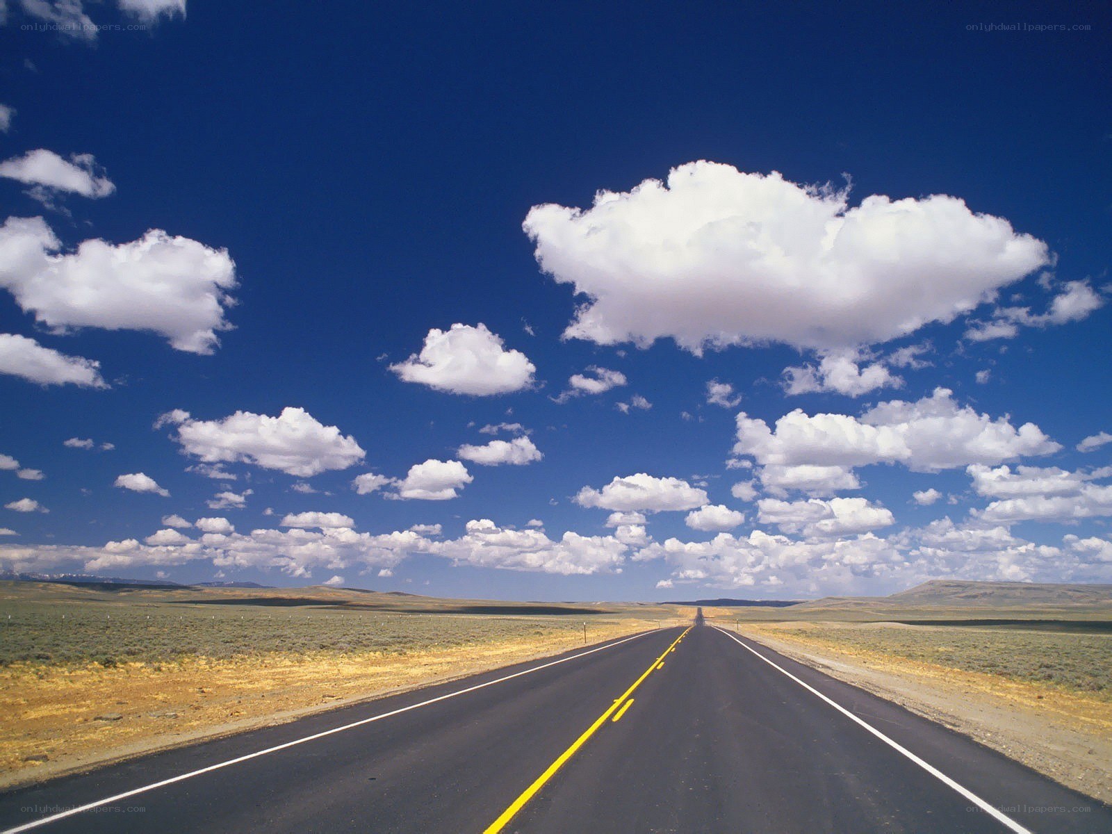Long road under blue sky