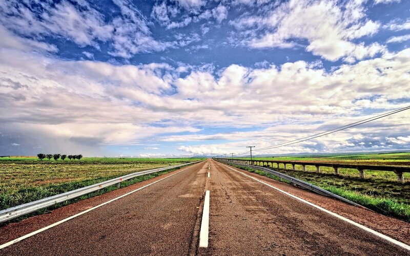 Long road under cloudy sky
