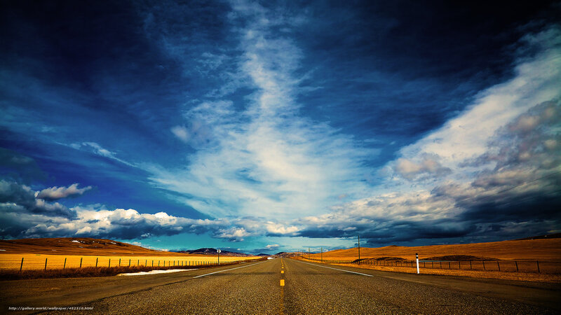 Long road under dramatic sky