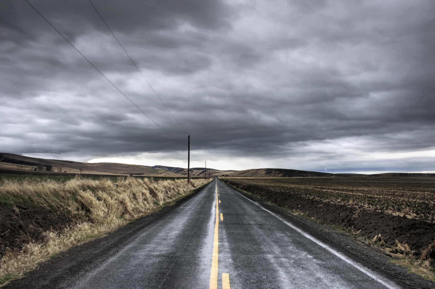 Long road under stormy sky