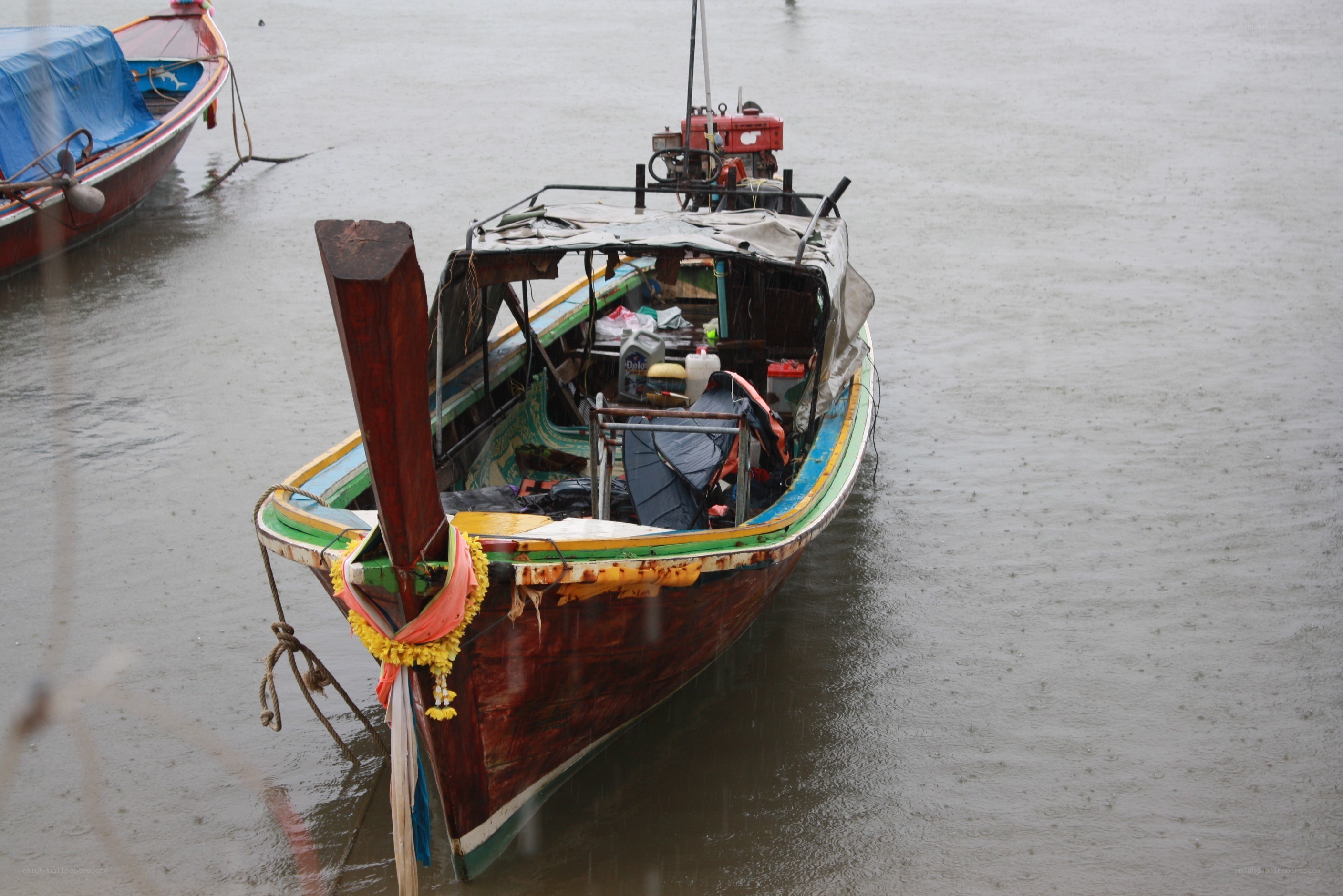 Long-tail boat in rain