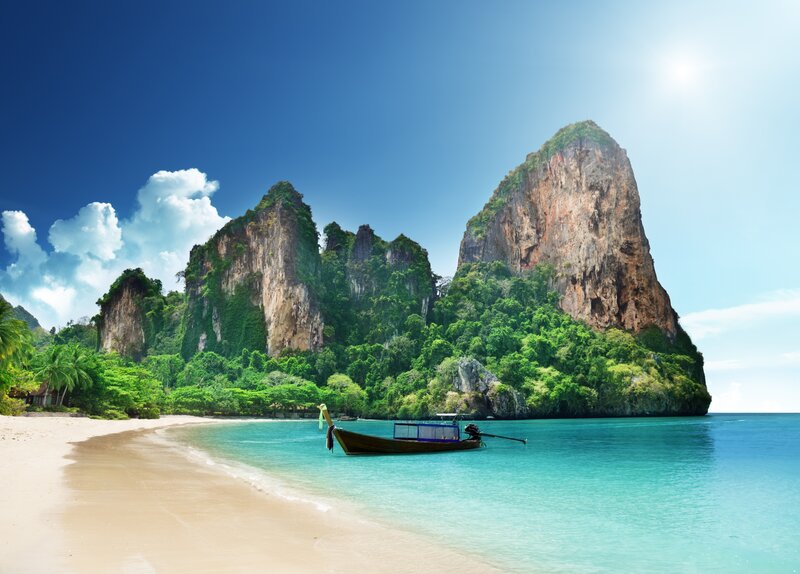 Long-tail Boat on Beach — Blue, Serene, Afternoon, Photograph, Cliffs, Trees